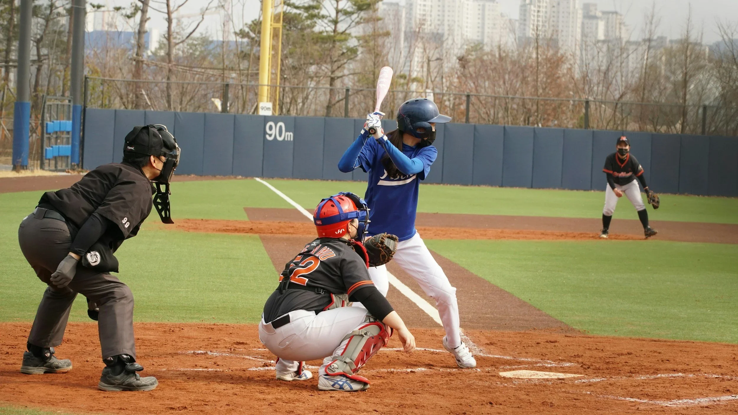 Baseball batter swinging as the catcher waits