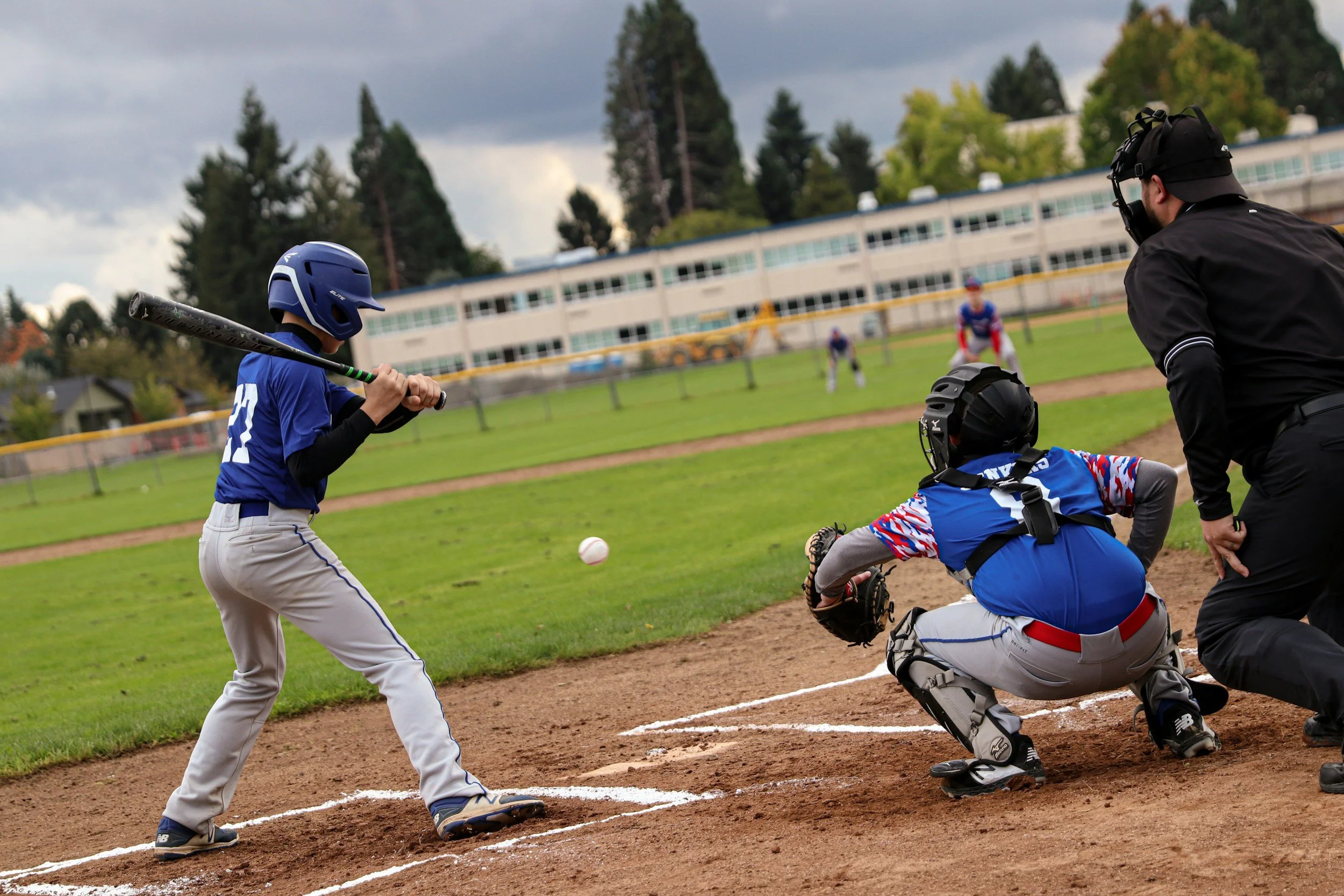 Baseball hitter facing a catcher and umpire