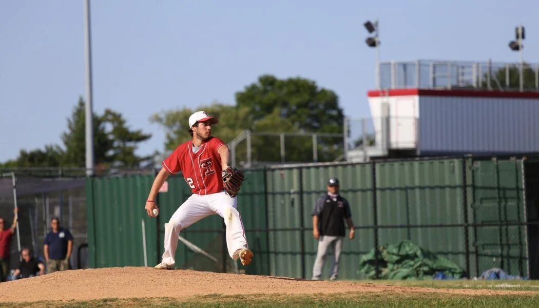 Baseball pitcher winding up on the mound