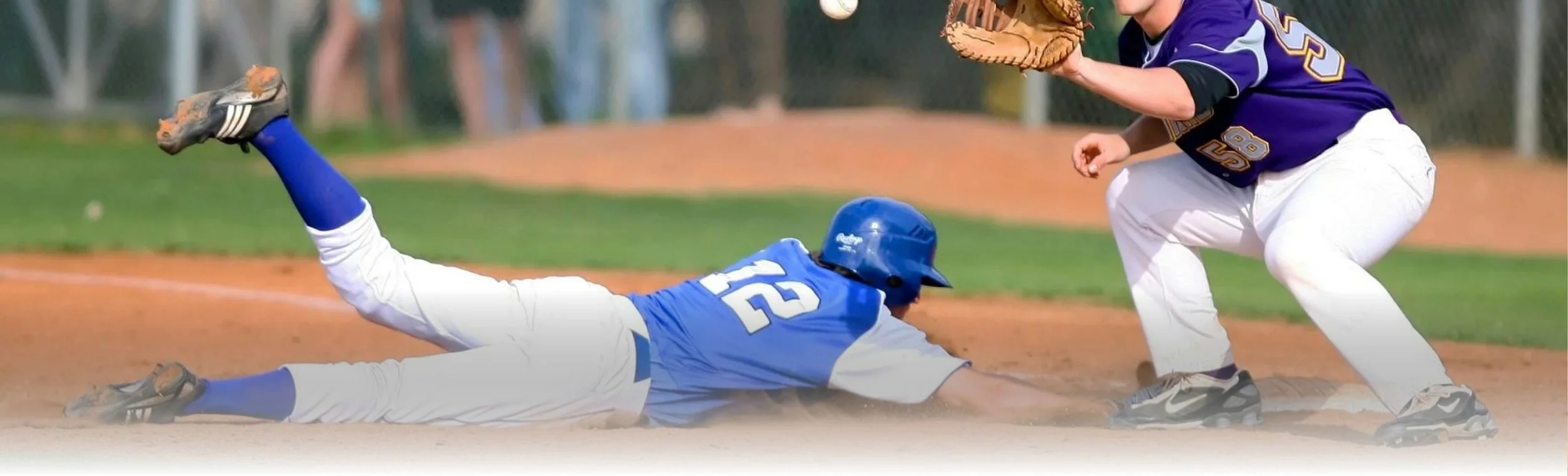 Baseball player sliding into a base
