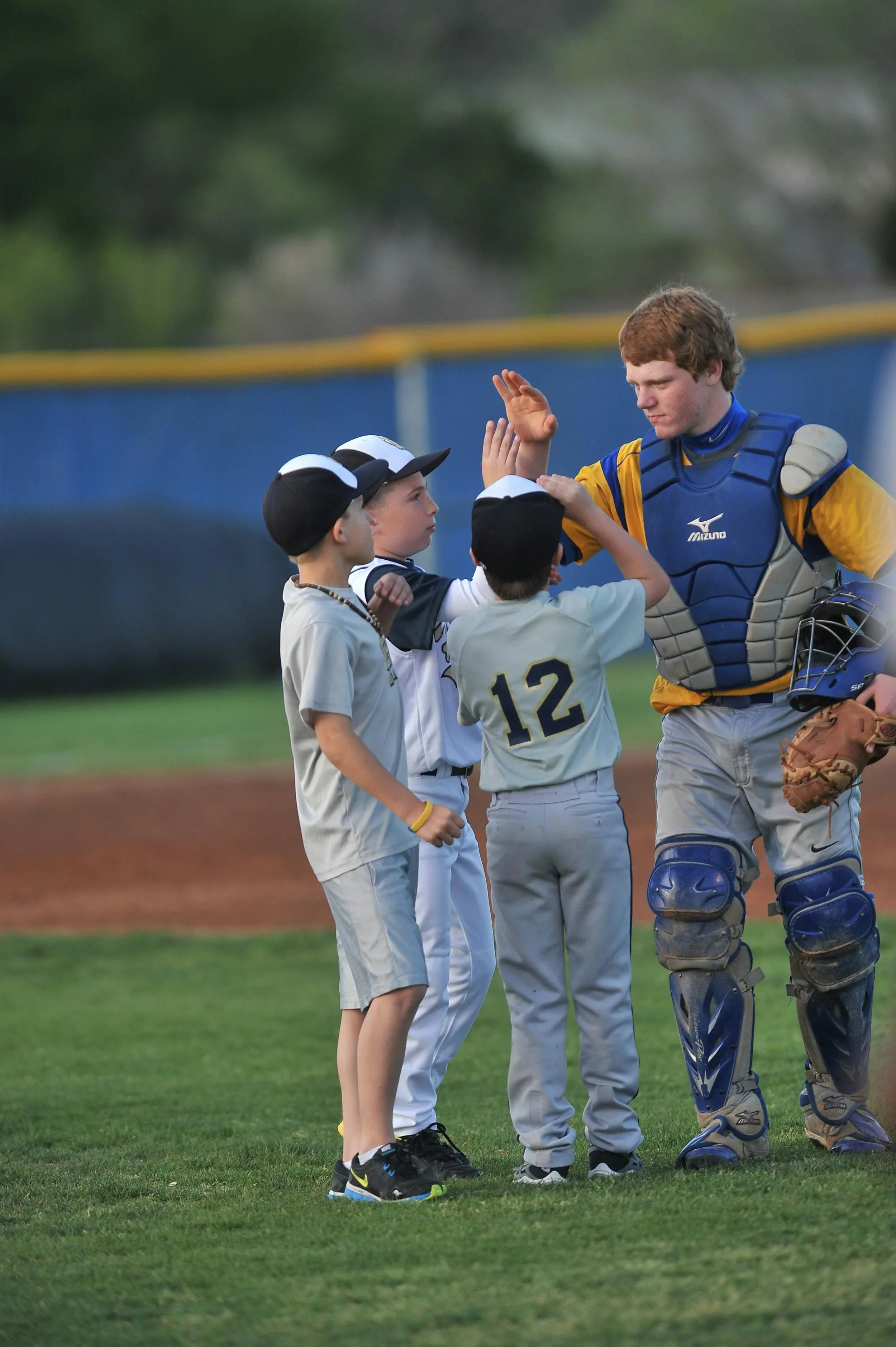 Coach talking with young baseball players