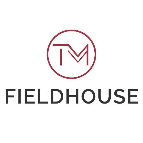 Logo with a circle containing the letters 'T' and 'M' above the word 'FIELDHOUSE' in bold black letters.