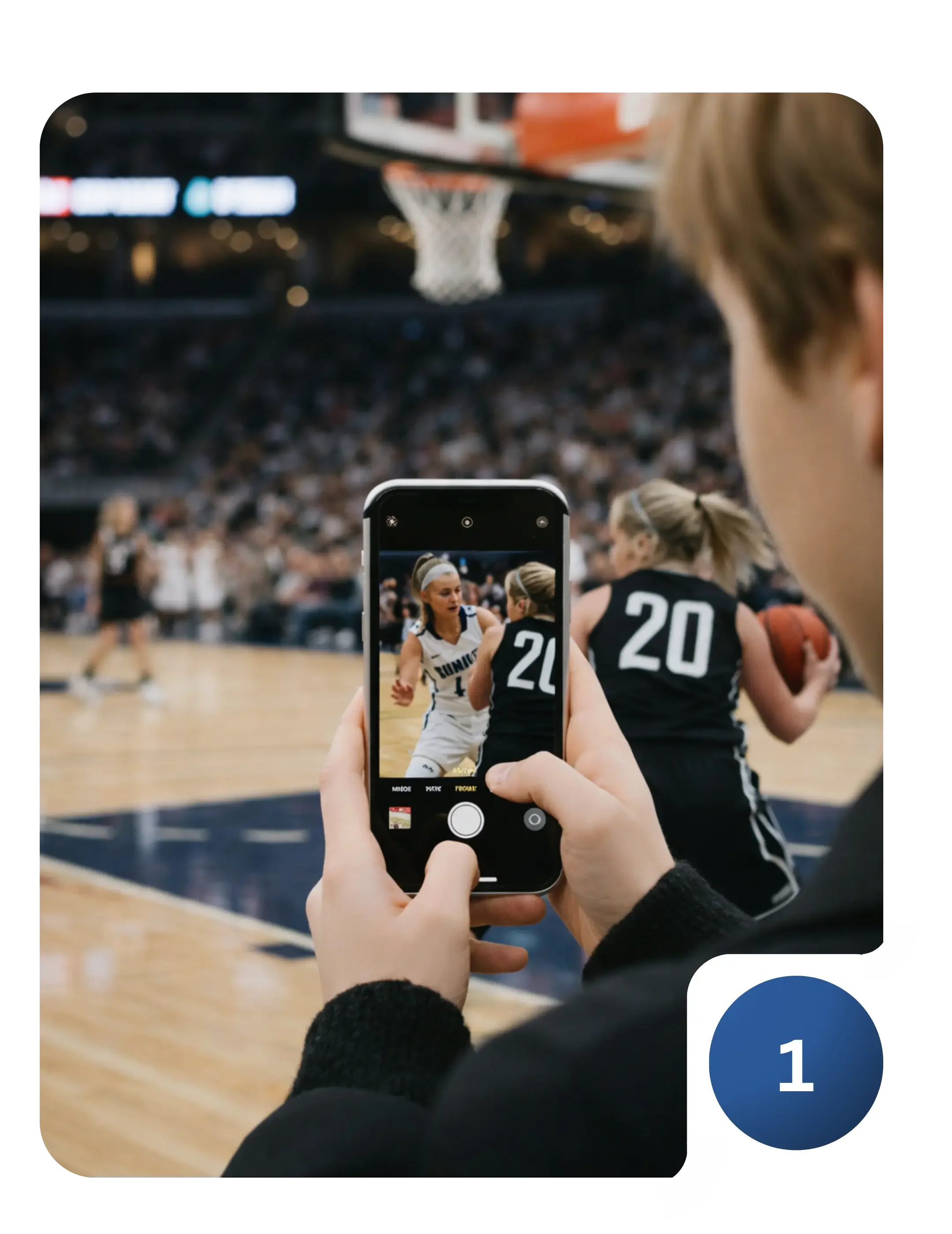 A person is using an iPhone to take a picture of two players in the middle of a basketball game.