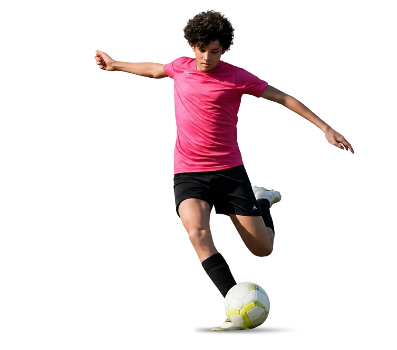 A person in a pink shirt and black shorts is playing with a soccer ball in a starting-kick motion.