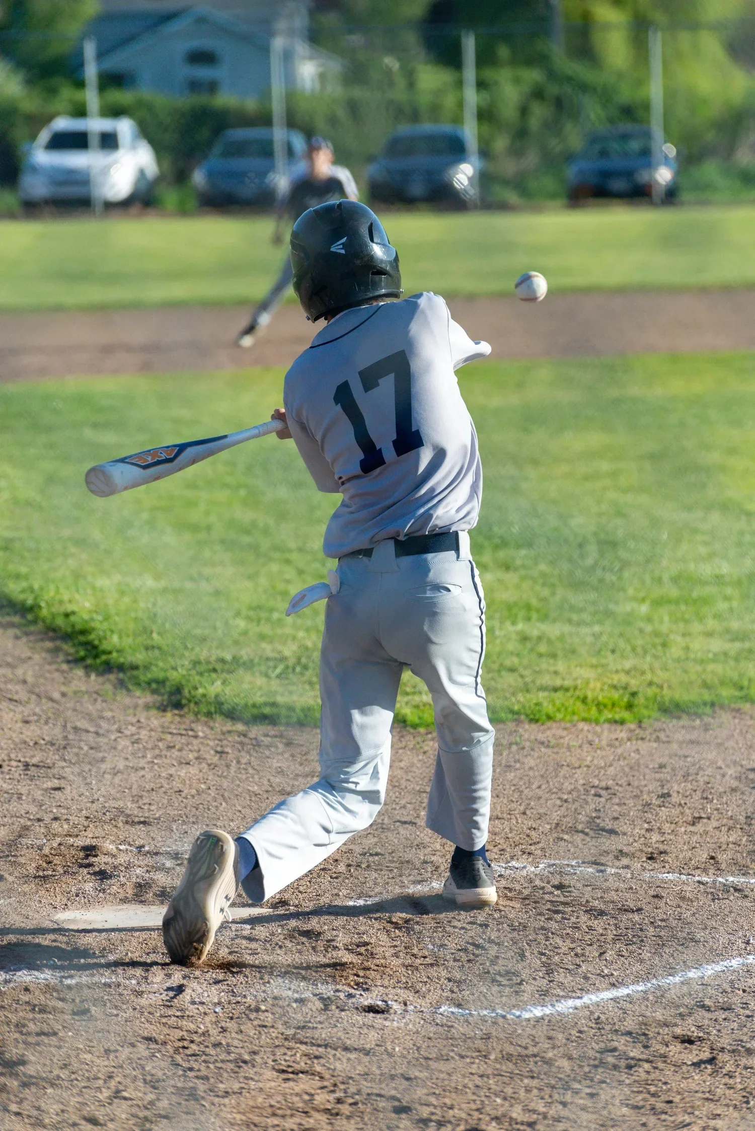 Young baseball player following through on a swing